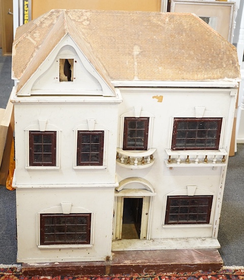 A large early 20th century J G Lines doll’s house, of plywood and tinplate construction, with two front opening sections and four internal rooms, 92cm high, 80cm wide, 60cm deep. Condition - fair